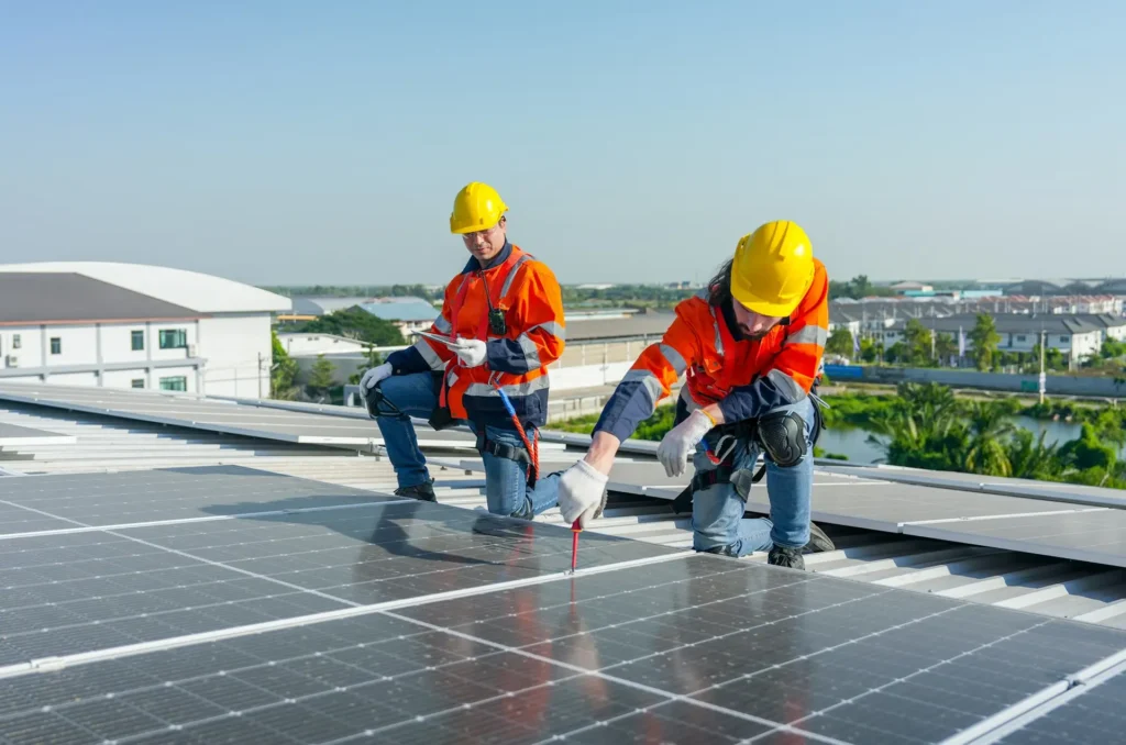 Caucasian technician workers use screwdriver to maintenance and fix the problem of the solar cell